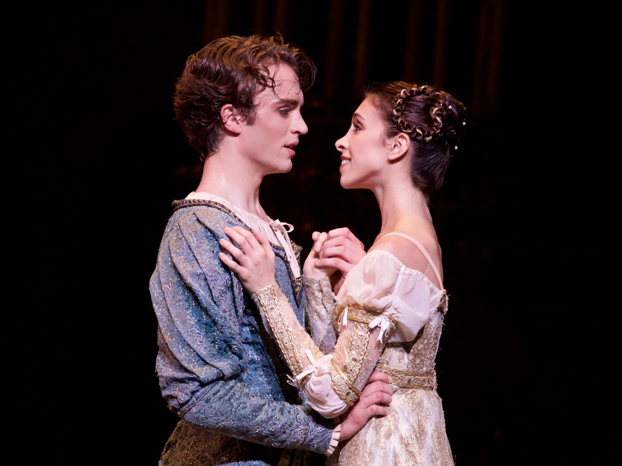 Ballet dancers performing onstage as Romeo and Juliet.
