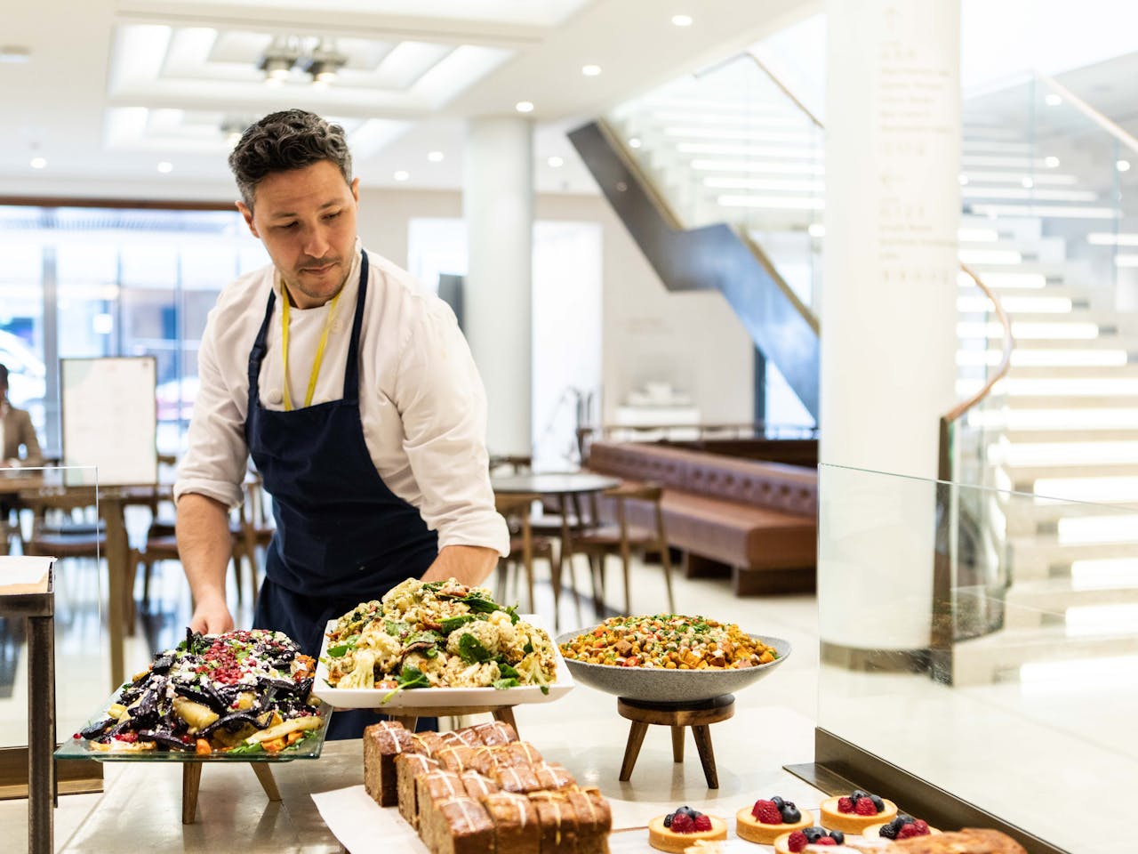 A chef arranges food at the Royal Opera House cafe.