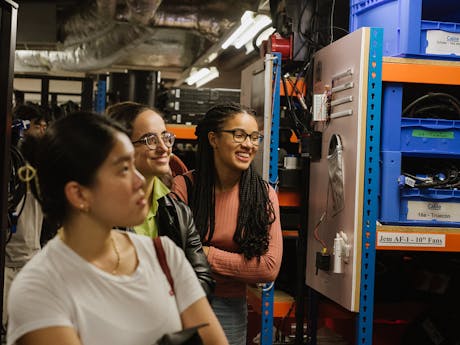 A group of young people on a backstage tour of the Royal Opera House.