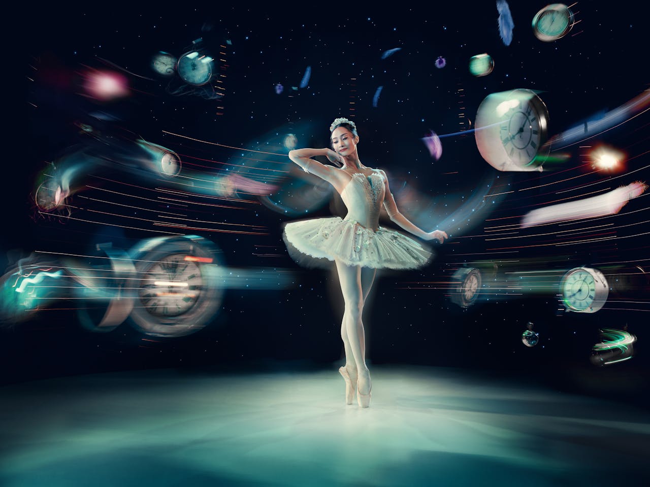 A ballerina, Fumi Kaneko as Cinderella, stands on pointe wearing a white sparkling tutu, surrounded by swirling clocks and lights in a surreal setting.